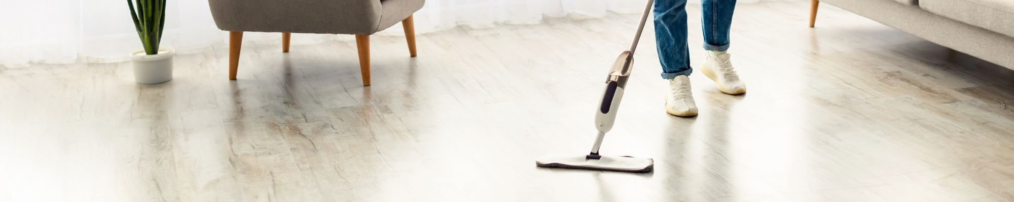 A modern living room featuring a stylish couch, a coffee table, and a television against a neutral backdrop.