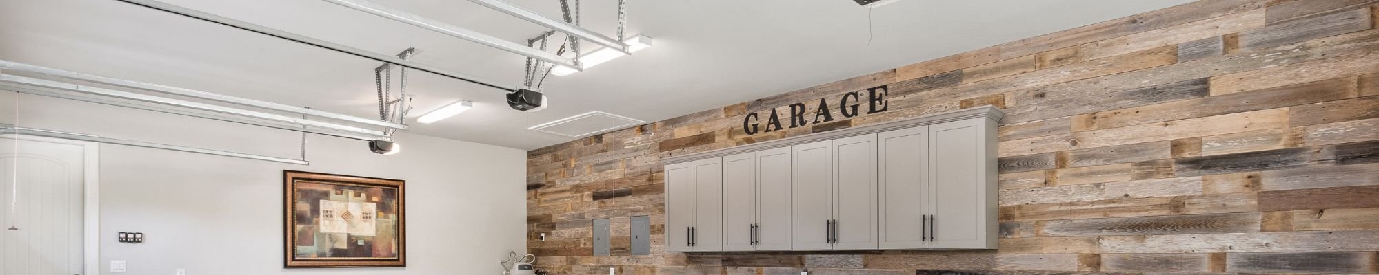 A modern garage featuring wooden walls and a sleek sink, designed for functionality and style.