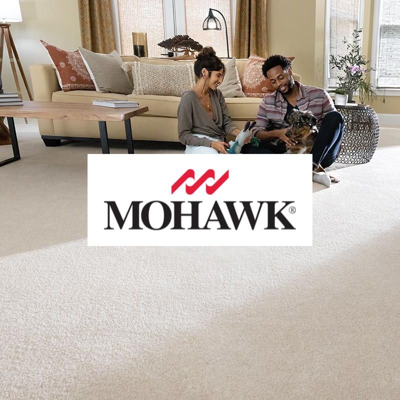 Mohawk carpet and flooring display showcasing various textures and colors in a well-lit showroom setting.