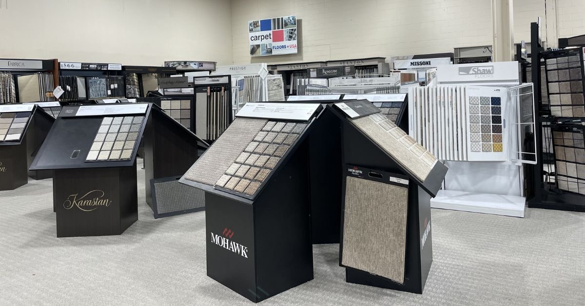 Floors USA display featuring a variety of carpet samples in different colors and textures arranged for customer selection.