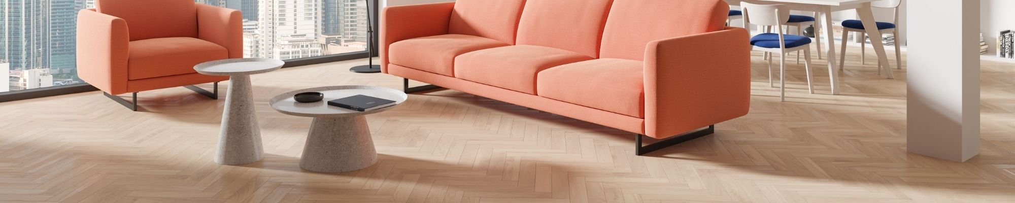 A modern office featuring orange furniture and a panoramic view of the city skyline through large windows.