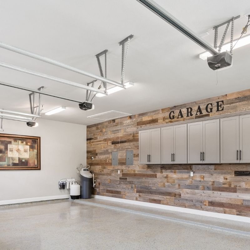 A modern garage featuring wooden walls and a sleek sink, designed for functionality and style.