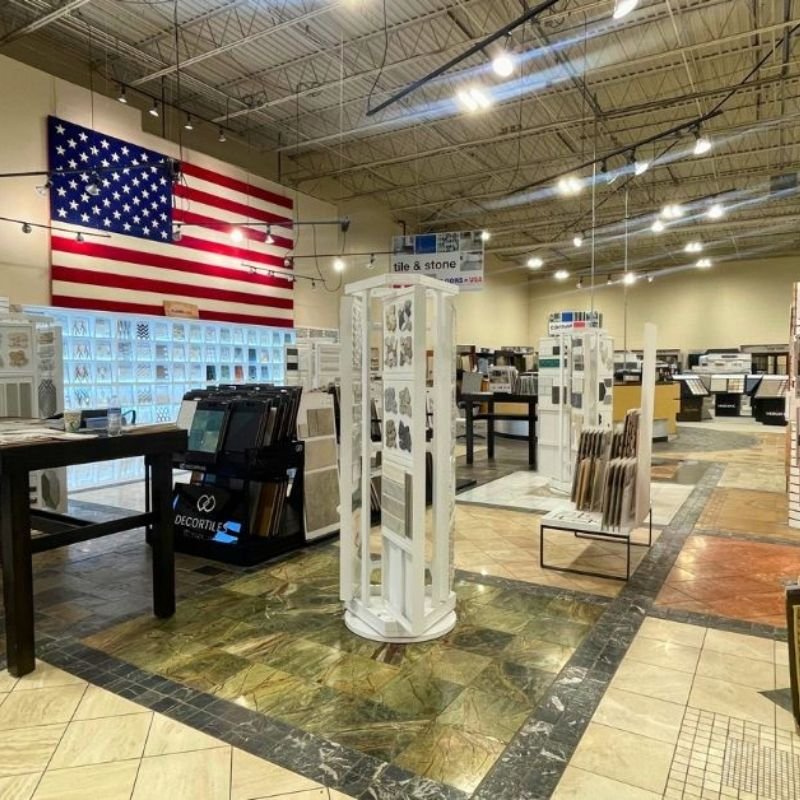 Floors USA interior featuring a large American flag prominently displayed from the ceiling.