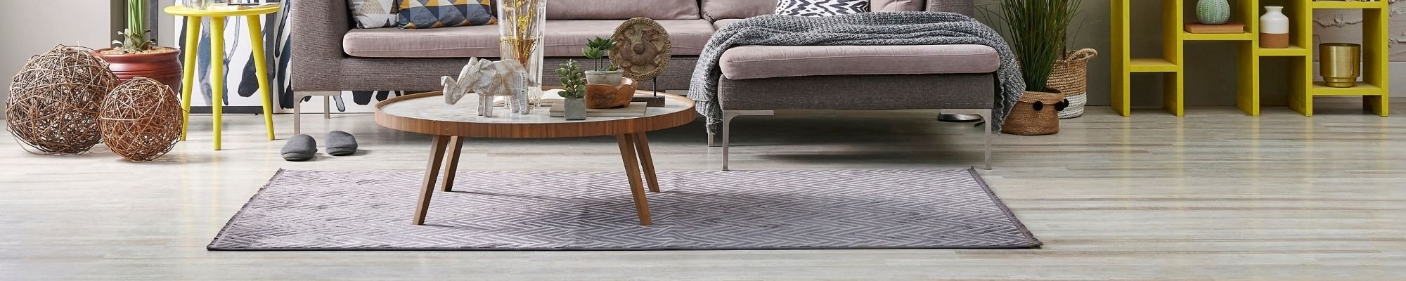 A cozy living room featuring a couch, a chair, and a table arranged for relaxation and socializing.