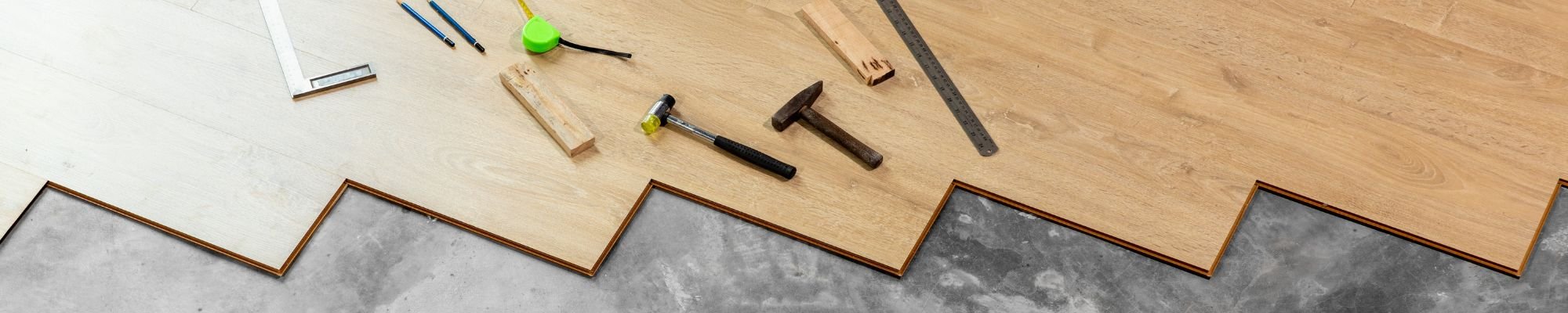 An interior space showcasing an assortment of tools on display, with polished wood flooring beneath.